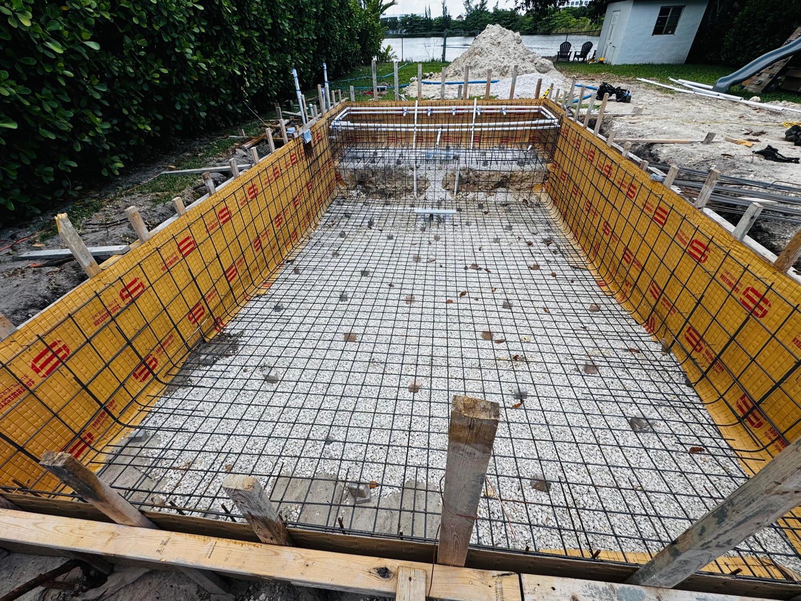 Residential pool shell with detailed plumbing and rebar