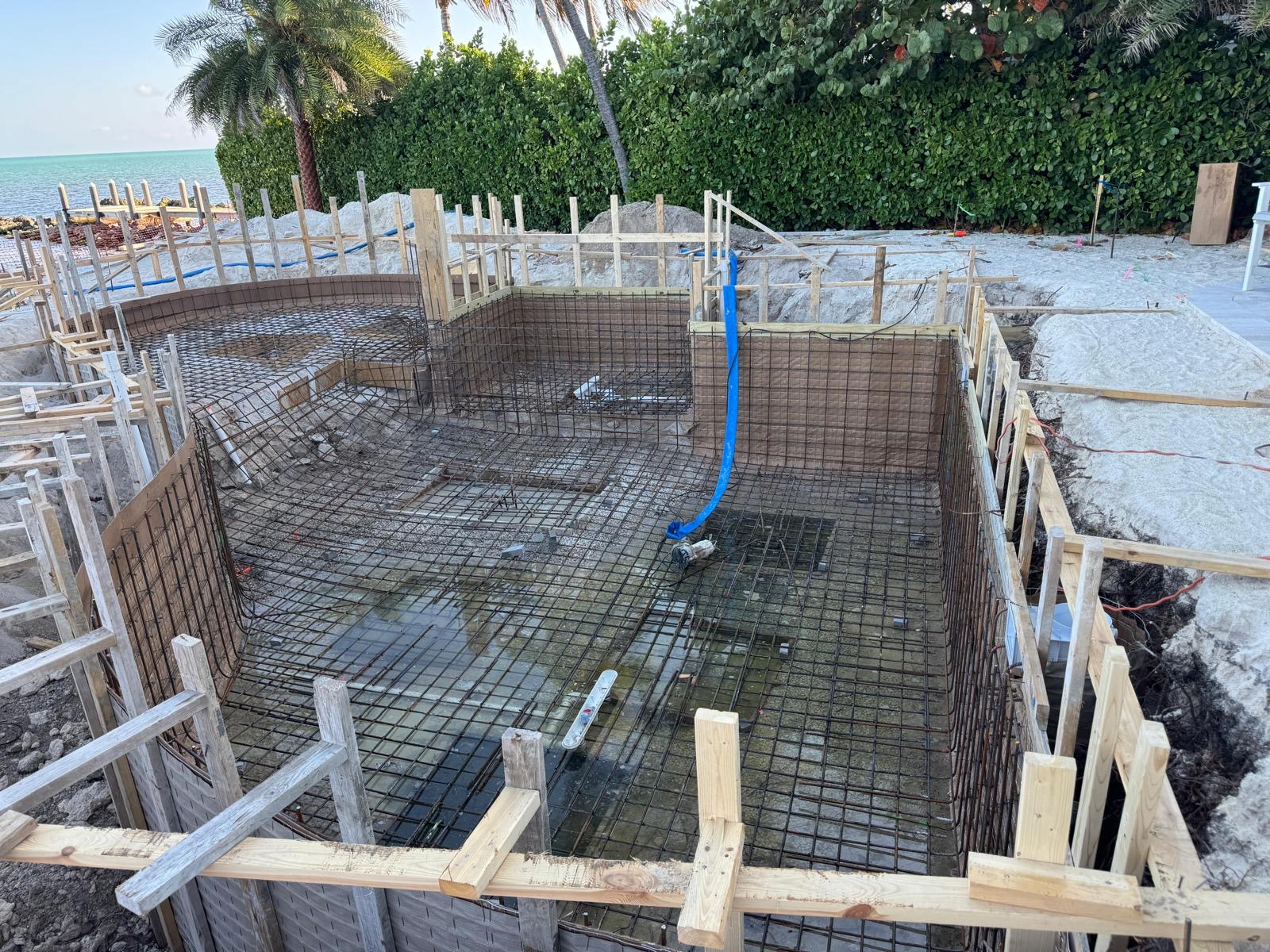 Curved waterfront pool shell with forms