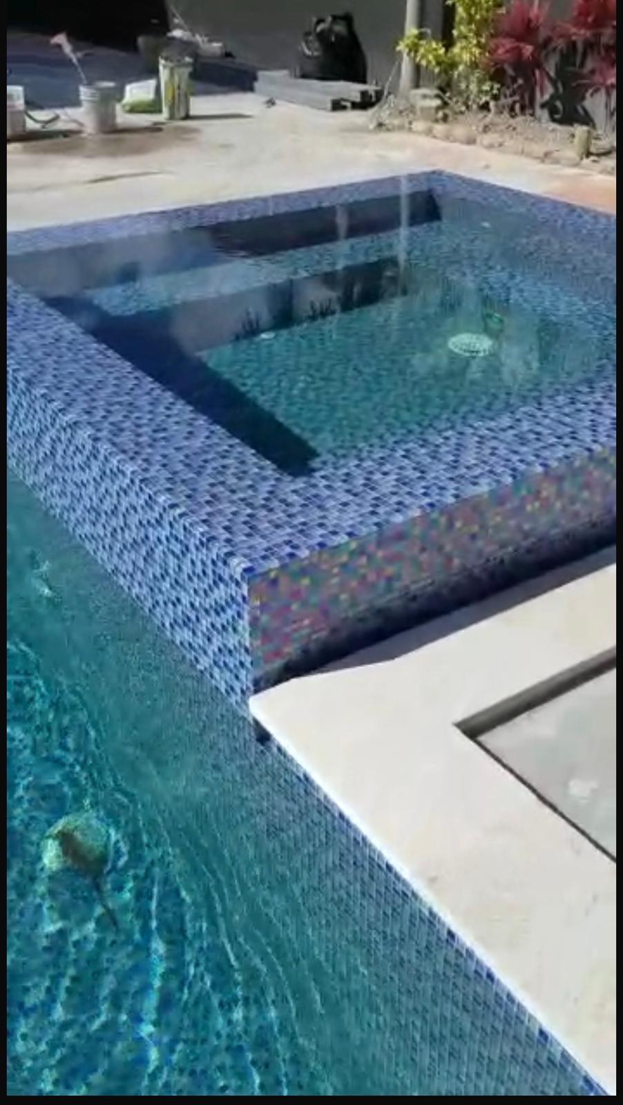 Raised spa with custom blue glass mosaic tiles